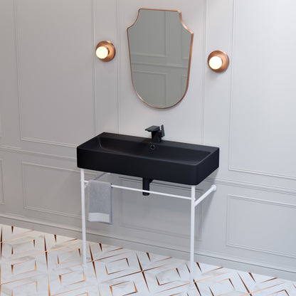 36-inch matte black ceramic console sink with matte white square legs and wall-mounted black faucet.