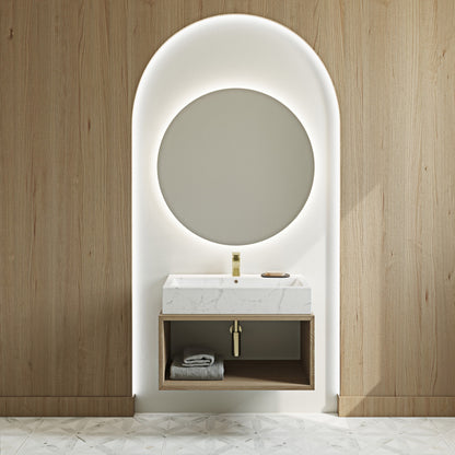 Voltaire wide rectangular vessel sink in white static marble with gold faucet and wall-mounted vanity.