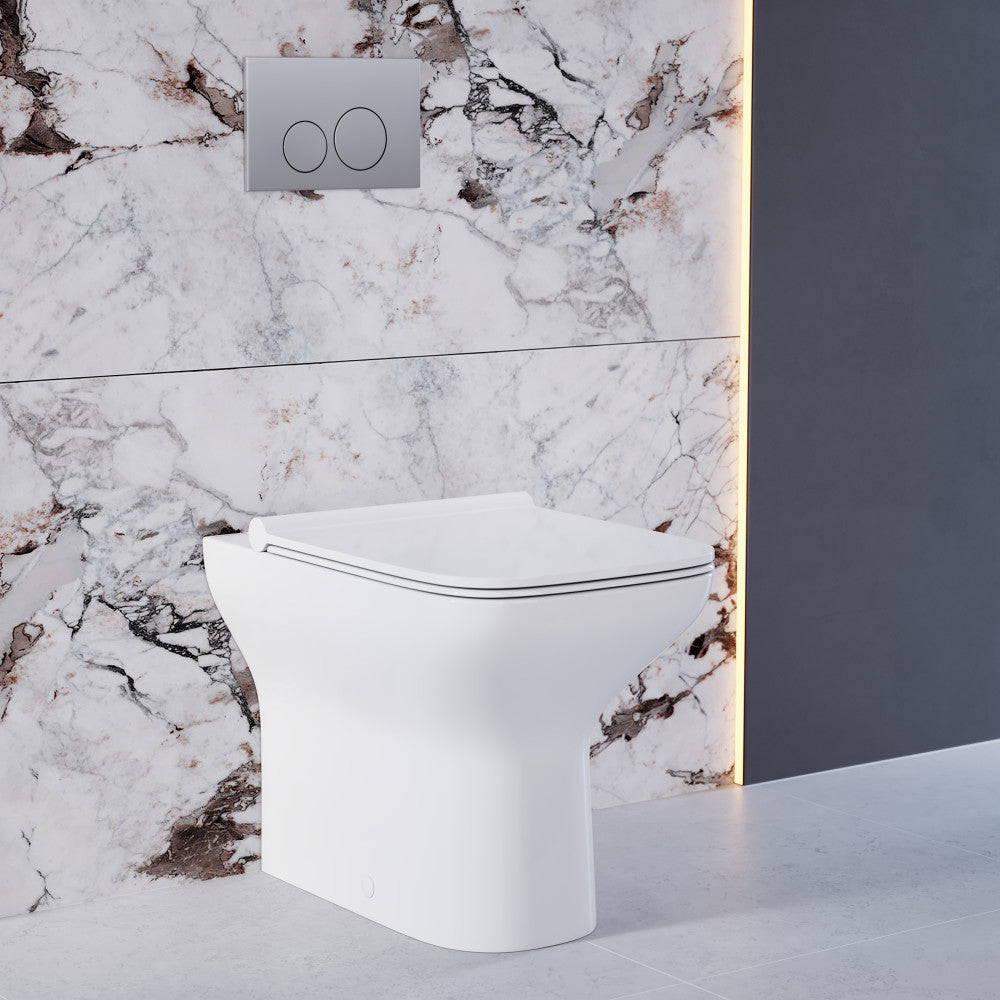 Compact back-to-wall toilet bowl in glossy white with soft-close seat and dual flush plate.