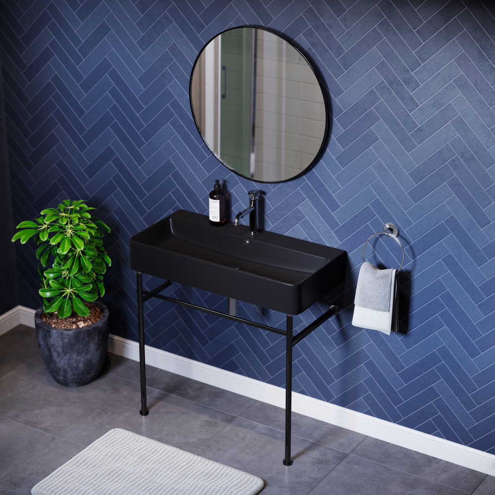 36-inch matte black ceramic console sink with black metal legs and single-hole faucet mount.