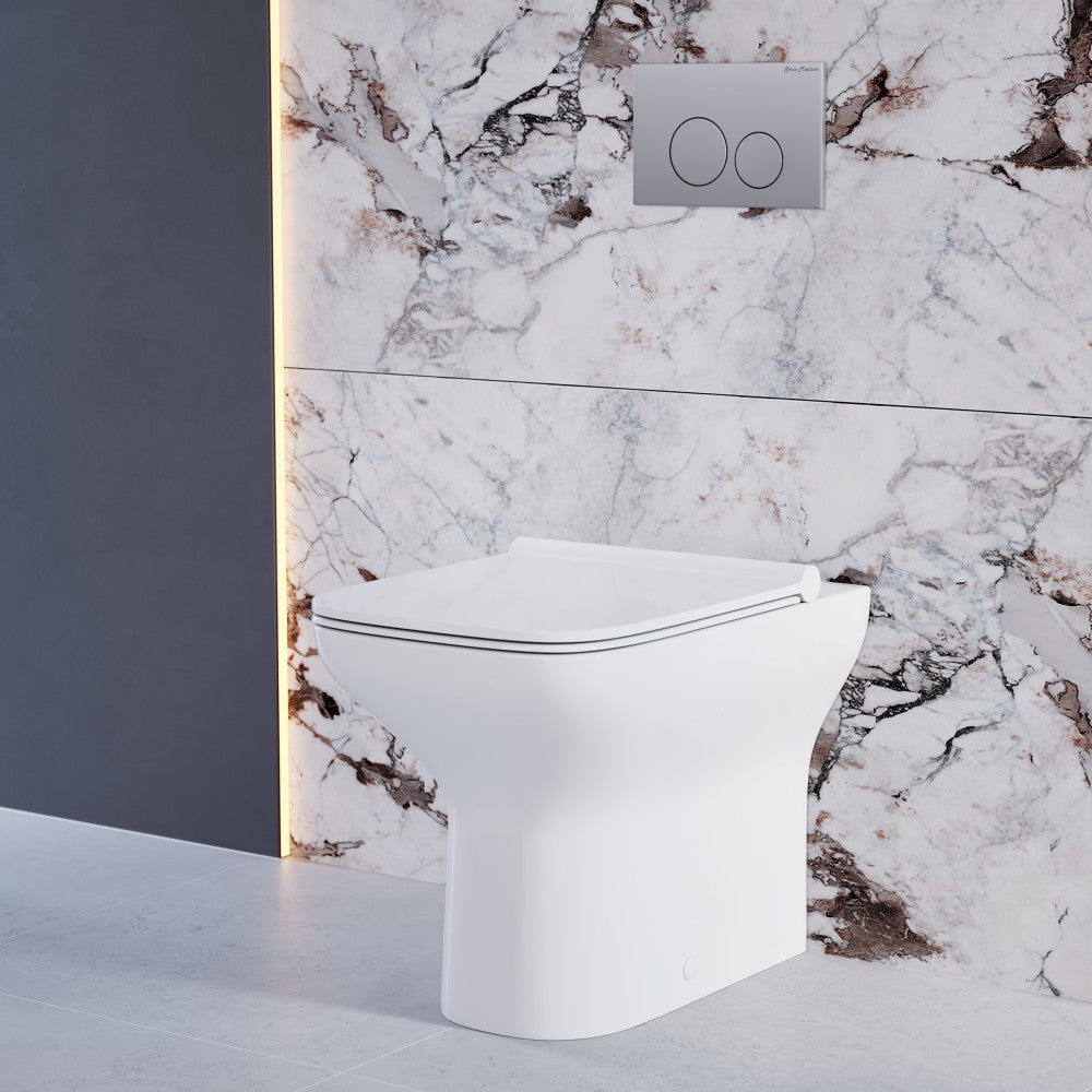 Glossy white back-to-wall toilet bowl with soft-close seat and dual flush buttons on marble wall.