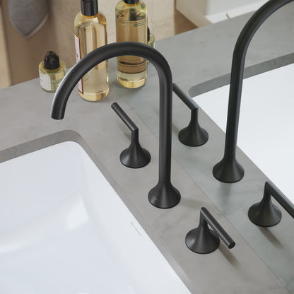 Widespread bathroom faucet in matte black with curved spout and dual lever handles on gray countertop.