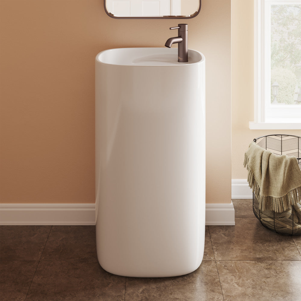 One-piece white pedestal sink with round basin and single-handle dark bronze faucet.