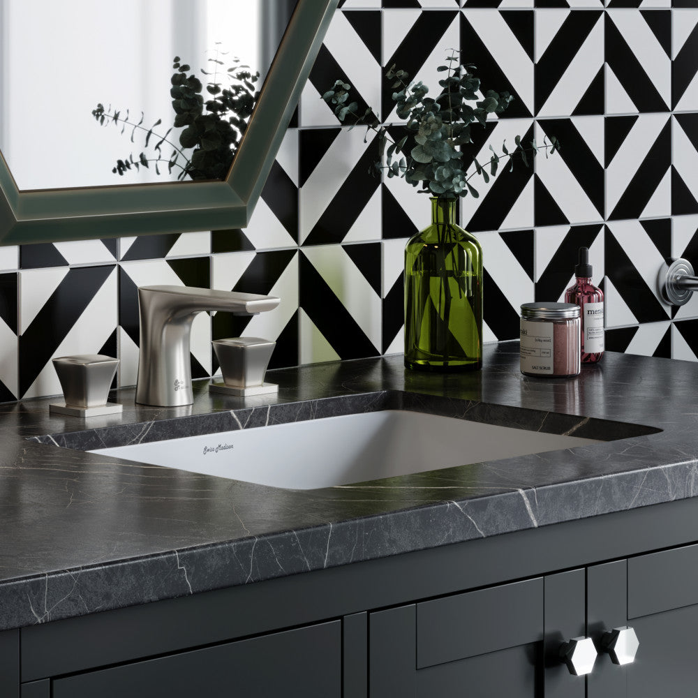 Rectangular undermount bathroom sink with matte black countertop and modern brushed nickel faucet.