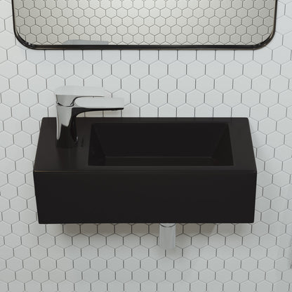 Rectangular matte black ceramic wall-hung sink with left side faucet mount and modern chrome faucet.