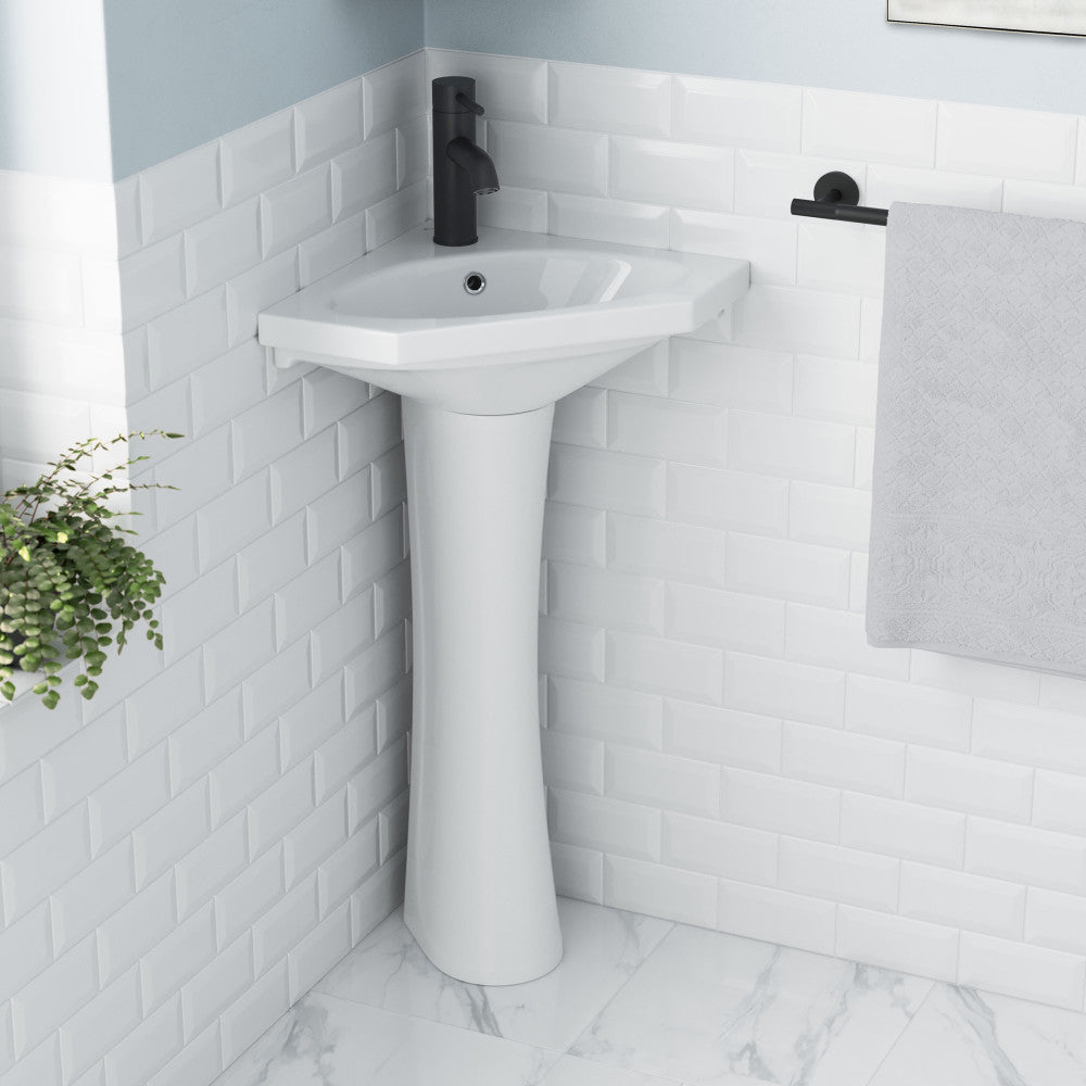 White two-piece pedestal sink with corner design and clean, classic lines.