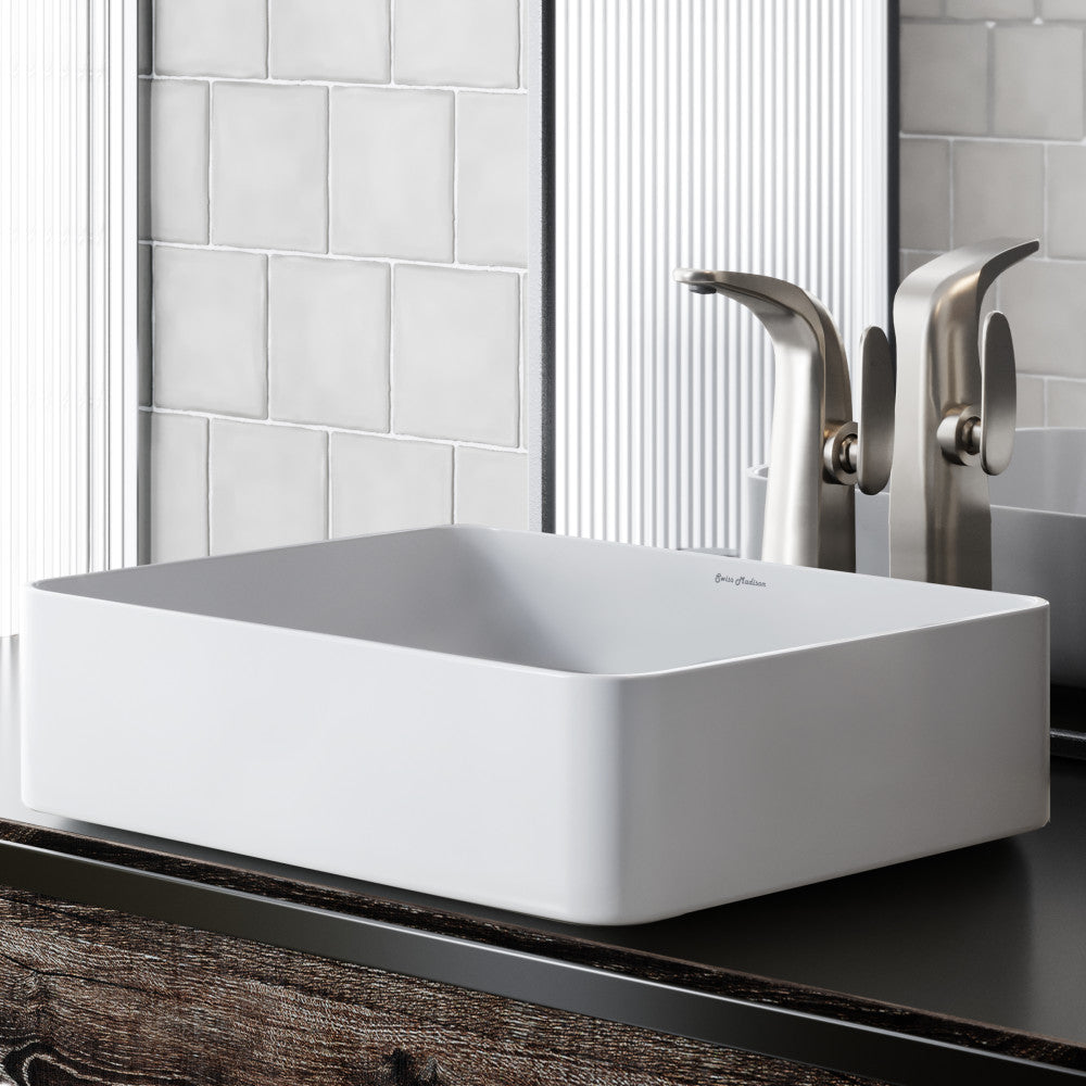 Rectangular white ceramic vessel sink with rounded corners and smooth matte finish.