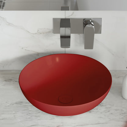 Round vessel ceramic bathroom sink in matte red with wall-mounted chrome faucet.