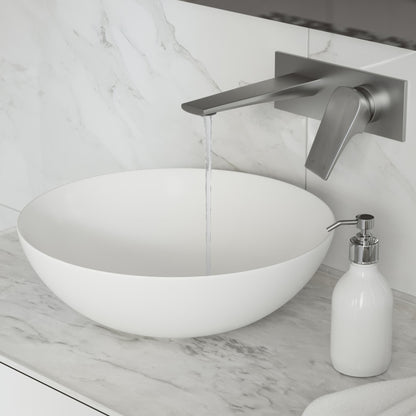 Wall-mount bathroom faucet in brushed nickel, single-handle, modern angular design with water flowing from spout.