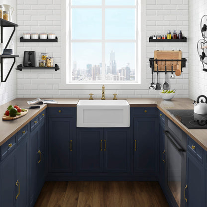 24 x 18 white ceramic farmhouse kitchen sink with apron front installed in navy blue cabinetry.