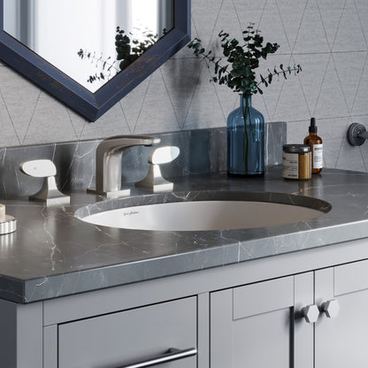 18-inch oval undermount bathroom sink in white with gray marble countertop and chrome faucet.
