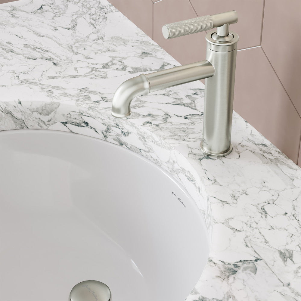 Single-handle bathroom faucet in brushed nickel with sleek cylindrical spout and lever handle.