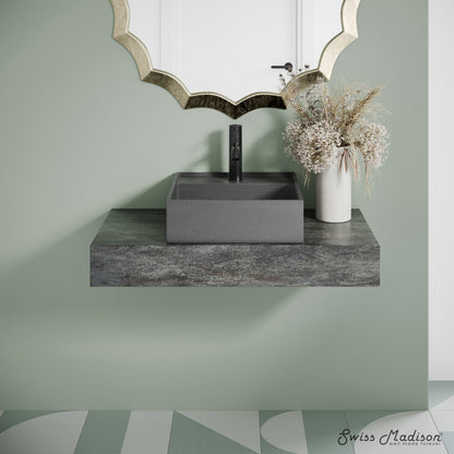 16" square concrete vessel bathroom sink in dark grey with matte black faucet on floating countertop.