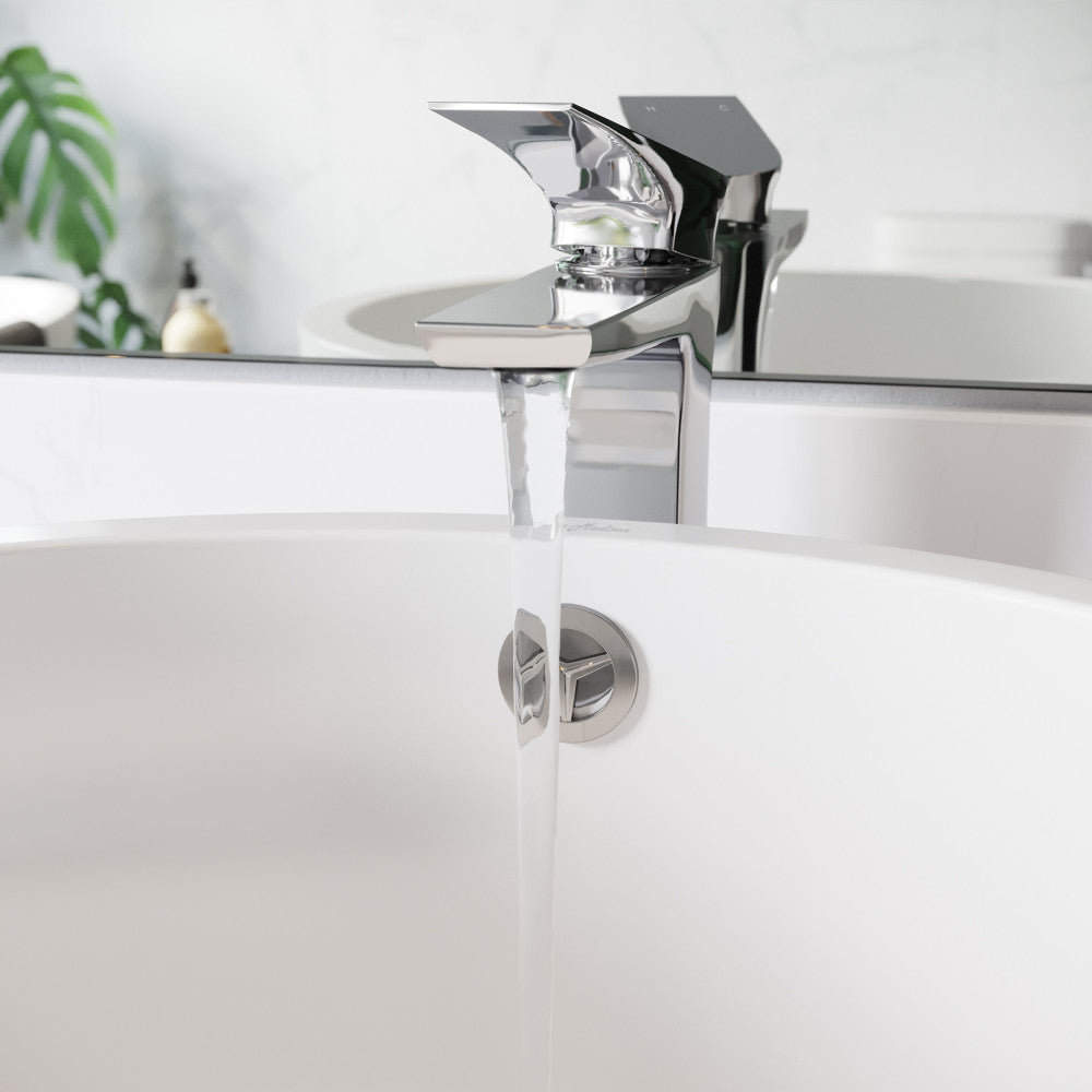 Single-handle high arc bathroom faucet in chrome, flowing water, modern sleek design.