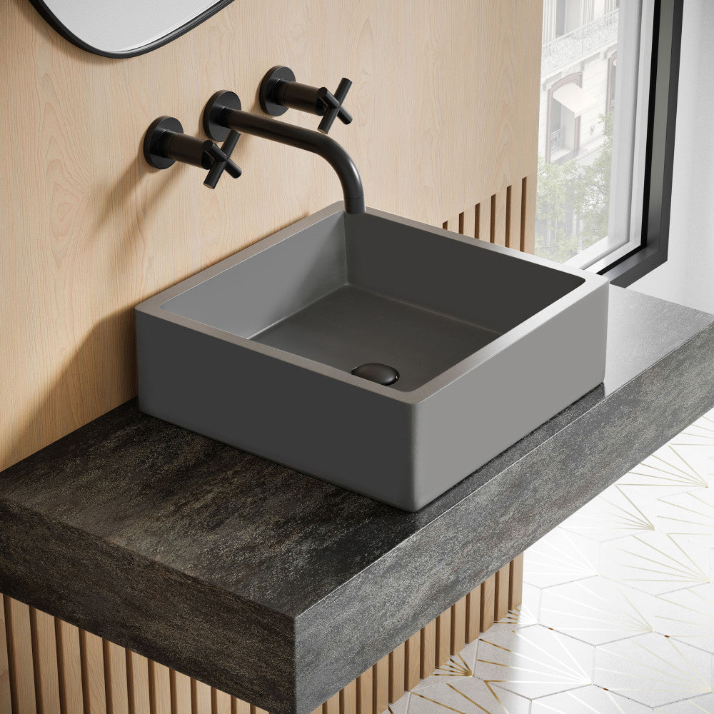 15.5" square concrete vessel sink in dark gray with matte black wall-mounted faucet.