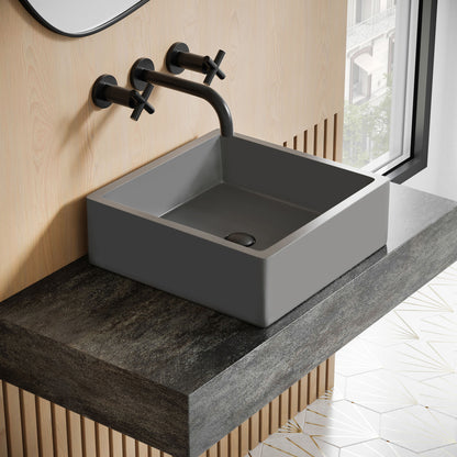 15.5" square concrete vessel sink in dark gray with matte black wall-mounted faucet.