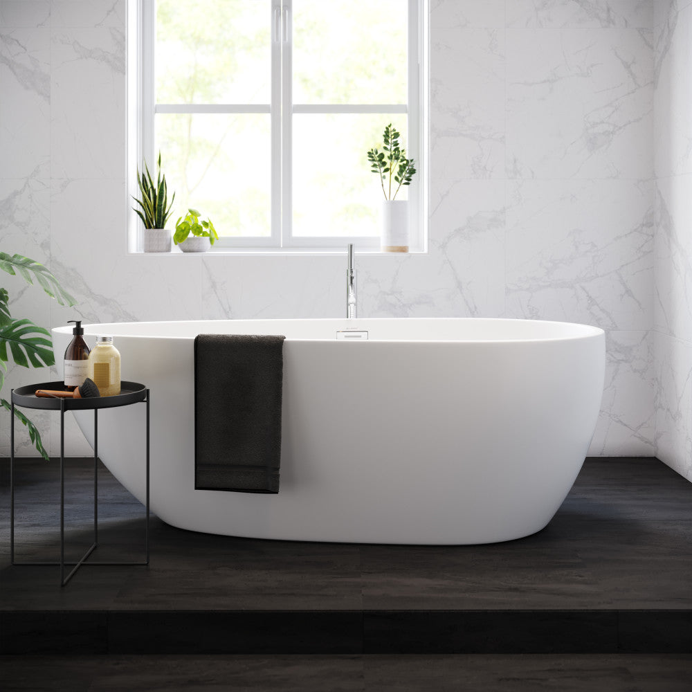 Freestanding soaking bathtub 67 inch, smooth white oval design with center drain and modern floor-mounted faucet.