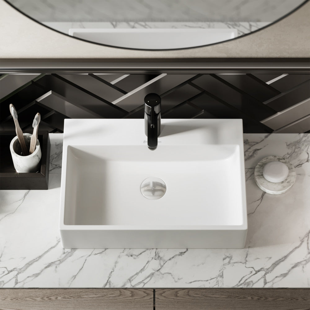 White rectangular ceramic vessel sink with single faucet hole, modern minimalist design, placed on marble countertop.