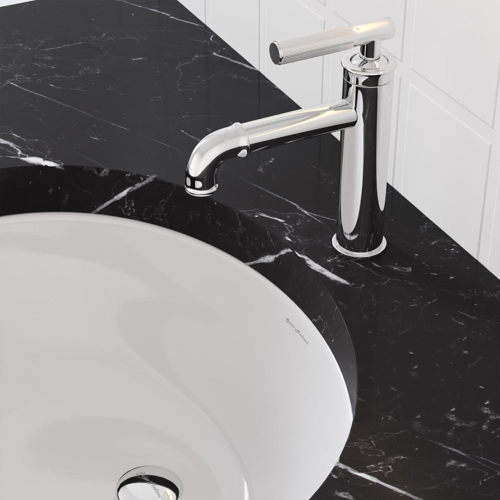 Single-handle bathroom faucet in chrome with sleek curved spout on black marble countertop.