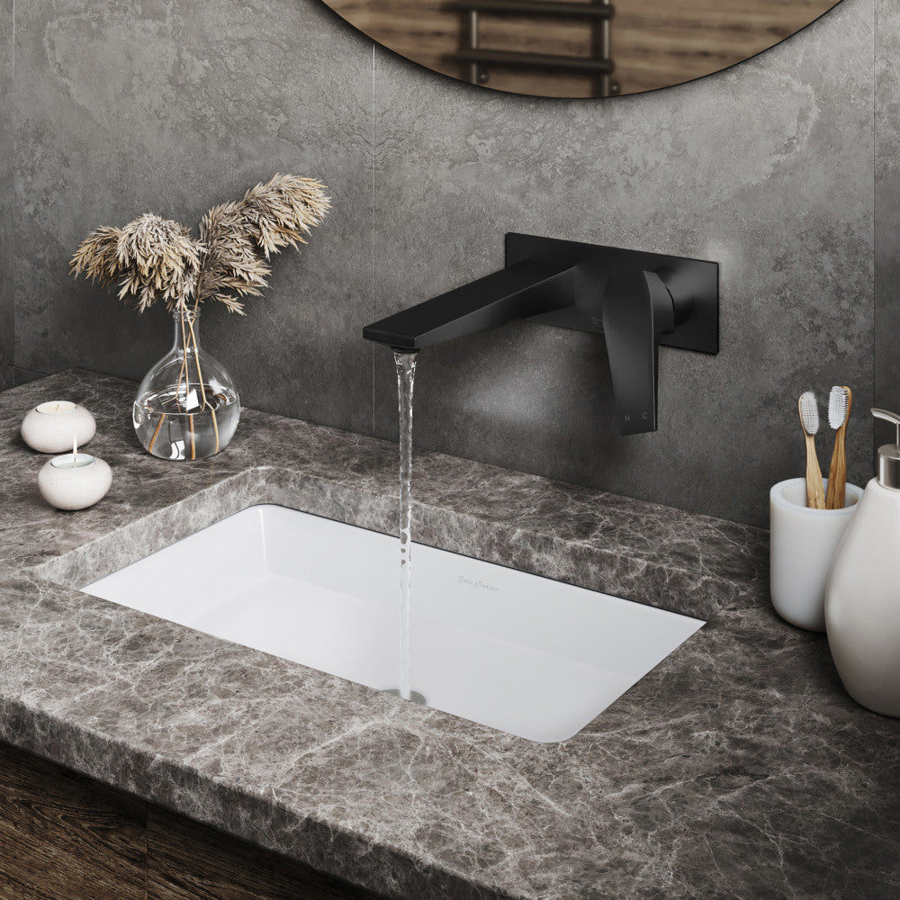 Wall-mount single-handle bathroom faucet in matte black with rectangular spout and minimalist design.