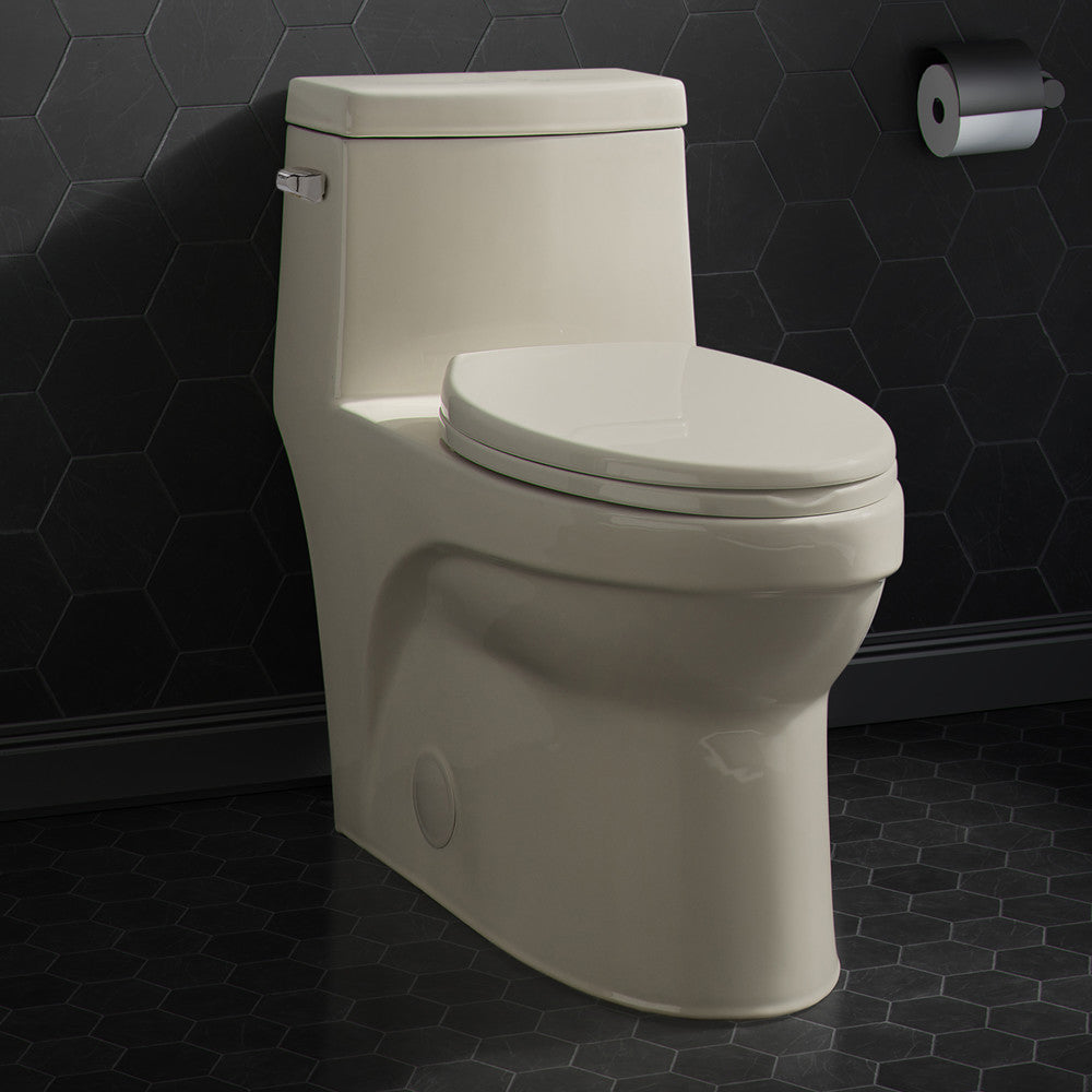 Elongated one-piece toilet in bisque with left side flush handle and smooth skirted trapway design.
