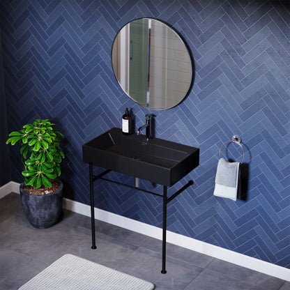 Matte black ceramic console sink with rectangular basin and slim black metal legs.