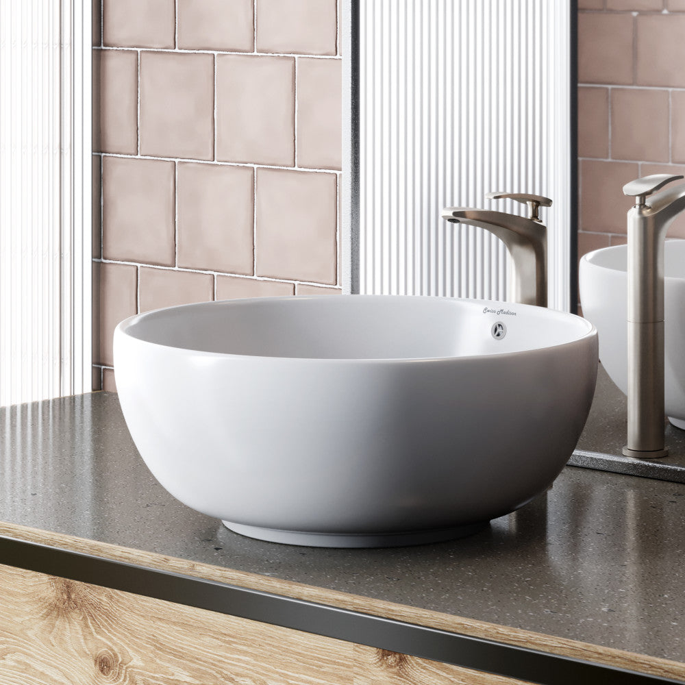 Round white vessel bathroom sink with smooth curved edges and drain hole.