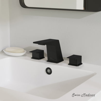 Widespread bathroom faucet in matte black with two square handles and angular spout on white countertop.
