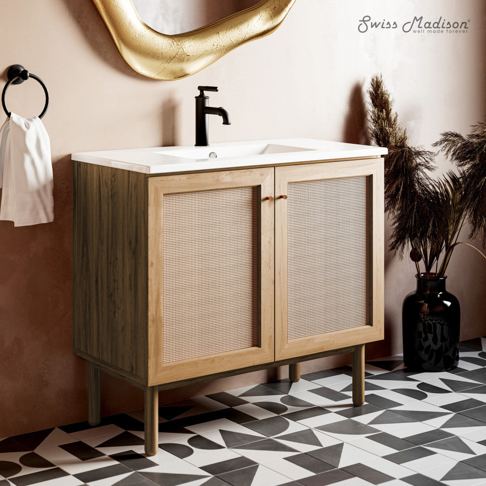 36-inch freestanding bathroom vanity in golden oak with single sink and black faucet.