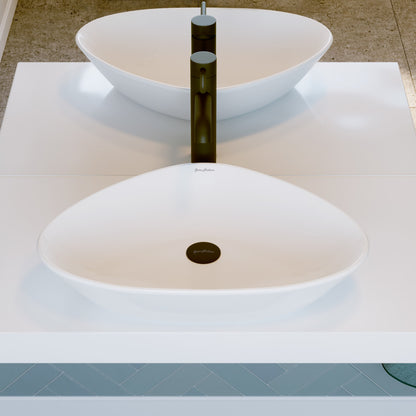 White oval ceramic vessel sink with black single-handle faucet on white countertop.