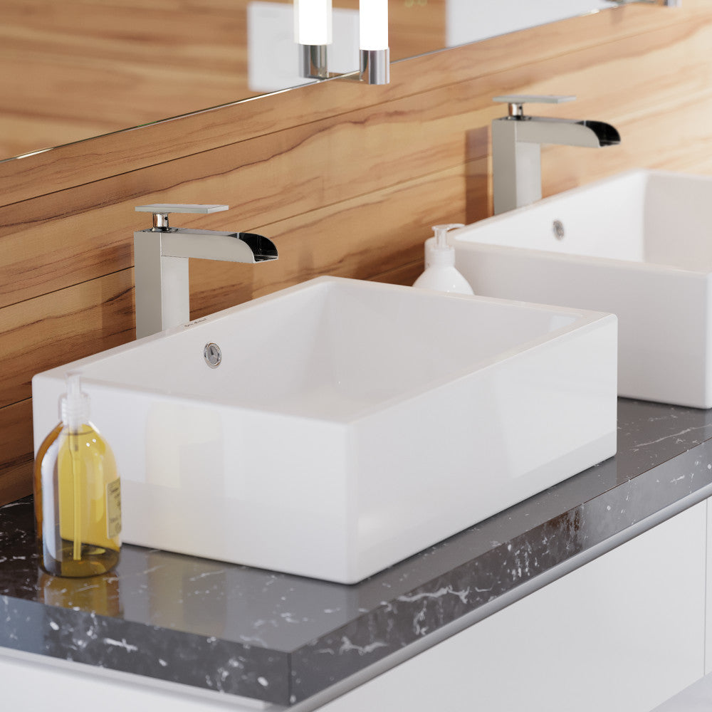 Rectangular white ceramic vessel sink with flat edges on gray marble countertop.