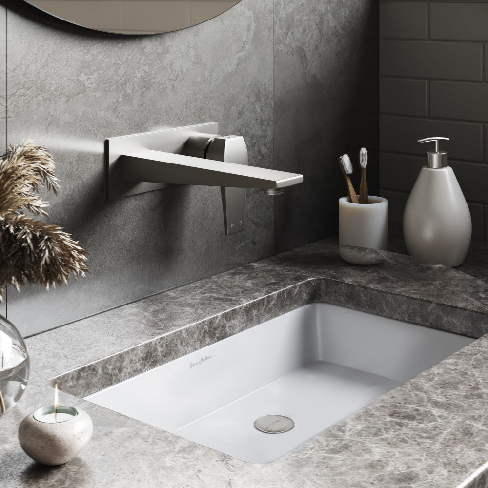 Rectangular under-mount bathroom sink in white with gray marble countertop.