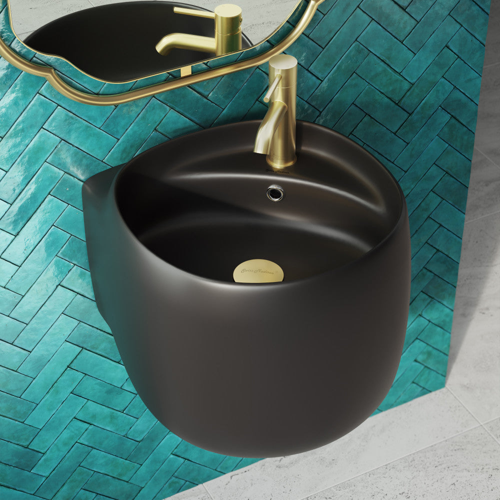 Wall-mount bathroom sink in matte black with rounded basin and gold drain cover.