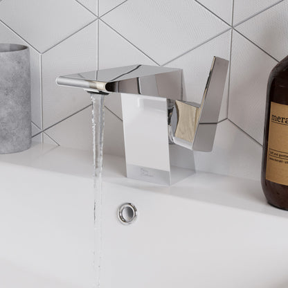 Single-handle Carre bathroom faucet in chrome, modern angular design with water flowing.