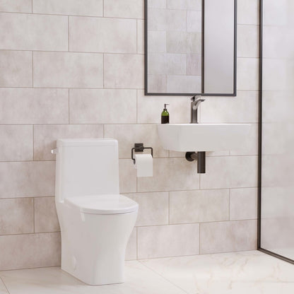 Round one-piece compact toilet in glossy white with left flush and skirted trapway.