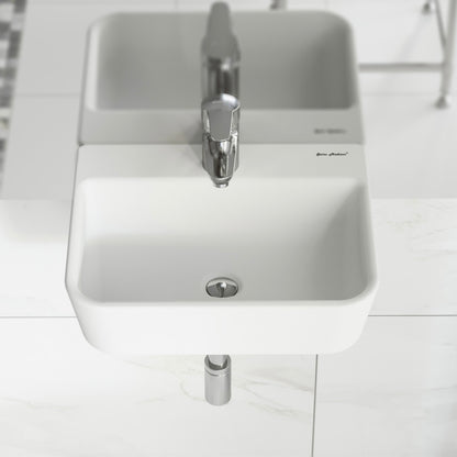 Small rectangular white wall-mount bathroom sink with single faucet hole and round drain.