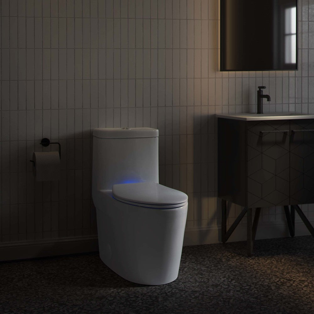 Elongated toilet with quick-release seat and blue night light, contemporary bathroom setting.