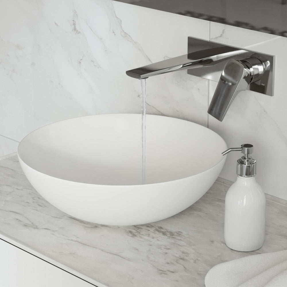 Wall-mount single-handle bathroom faucet in chrome above white round vessel sink on marble countertop.