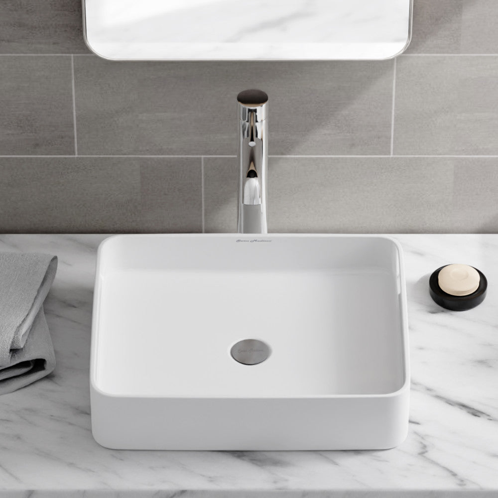 19-inch white rectangular ceramic vessel sink with central drain hole and smooth edges.