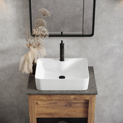 19-inch glossy white rectangular vessel sink with rounded corners on wooden vanity, black faucet.