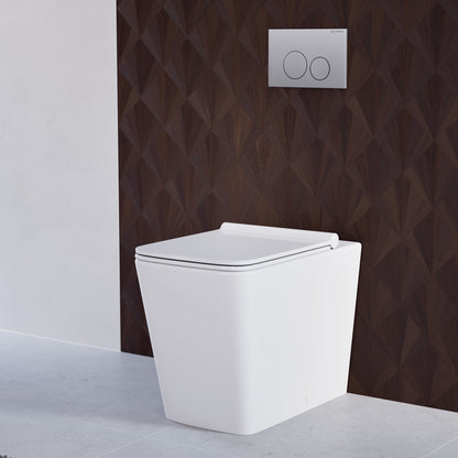 Glossy white back-to-wall toilet with concealed tank and soft-close seat against textured dark wall.