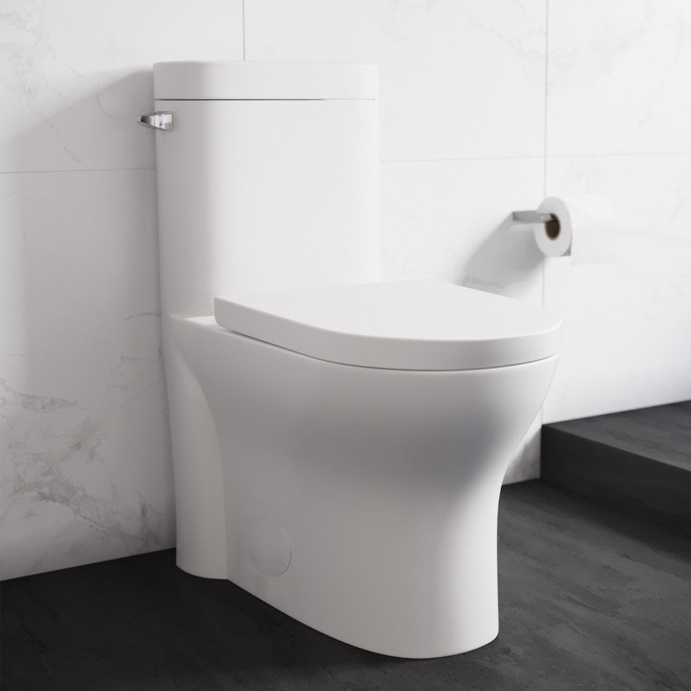 Elongated one-piece toilet with left side flush handle, modern white design, compact skirted trapway.