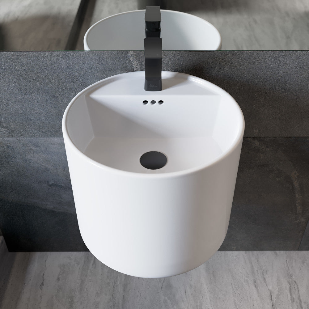 18-inch round wall-mount bathroom sink in white with black single-handle faucet.