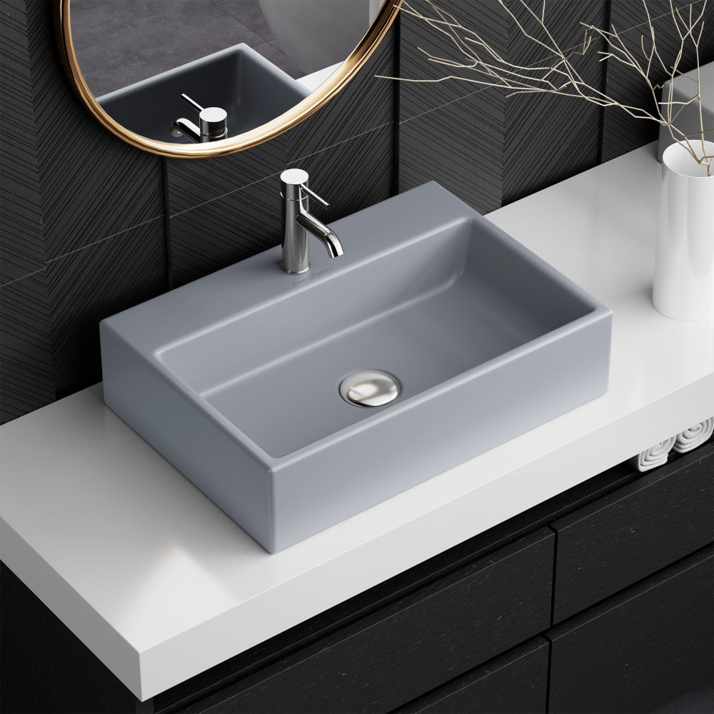 20" rectangular matte gray ceramic vessel sink with flat sides and central drain hole.