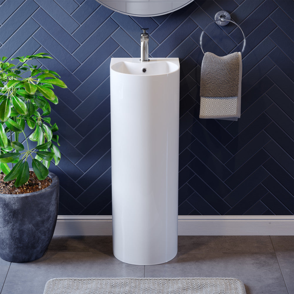 Rounded pedestal bathroom sink in white with single hole faucet and integrated basin.