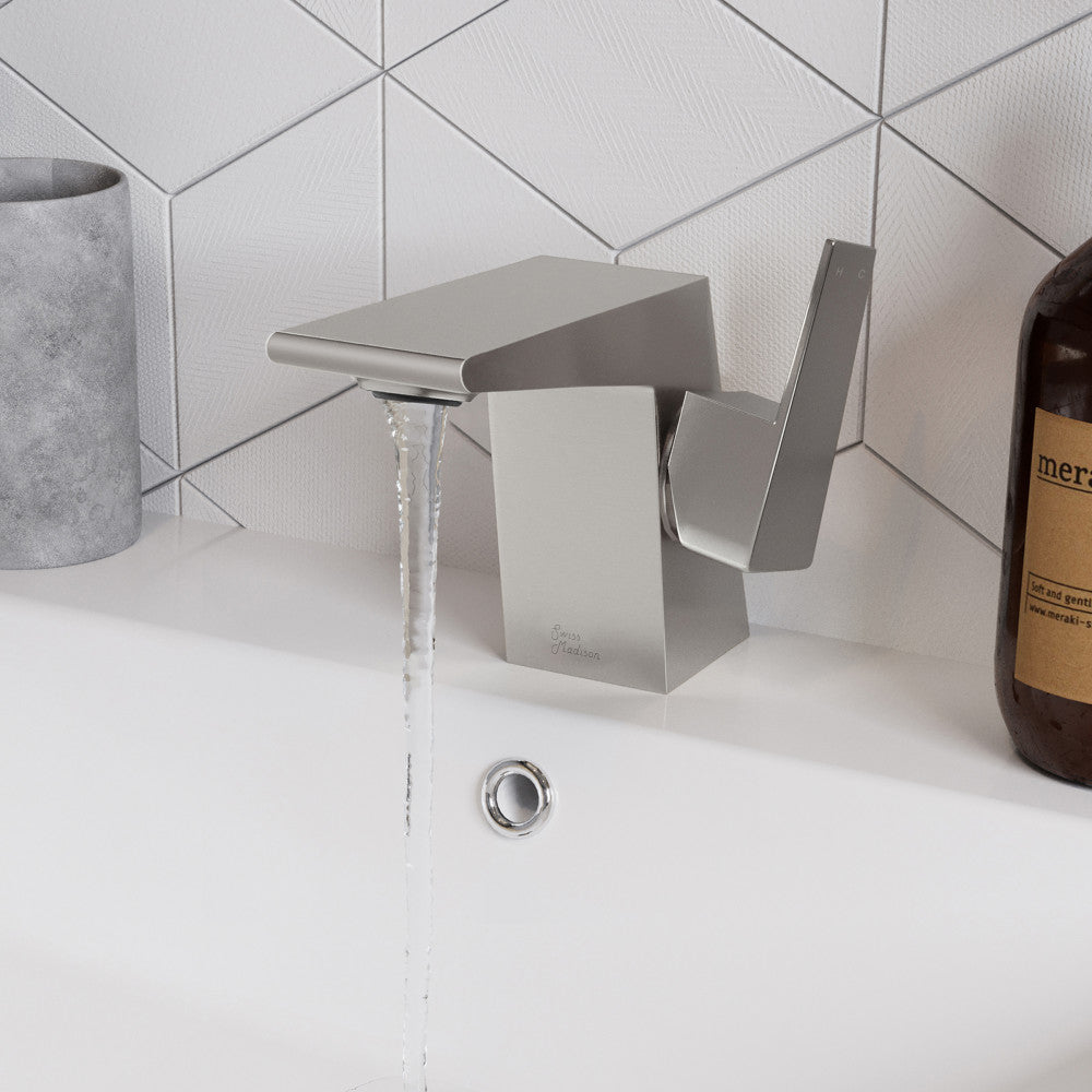 Single-handle bathroom faucet in brushed nickel, square modern design, water flowing from spout.