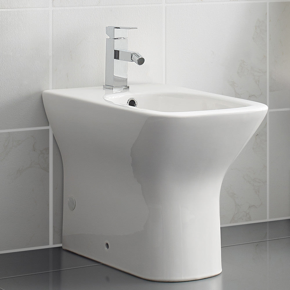 Floor-mount classic bidet in glossy white with modern single-handle faucet and smooth curved design.