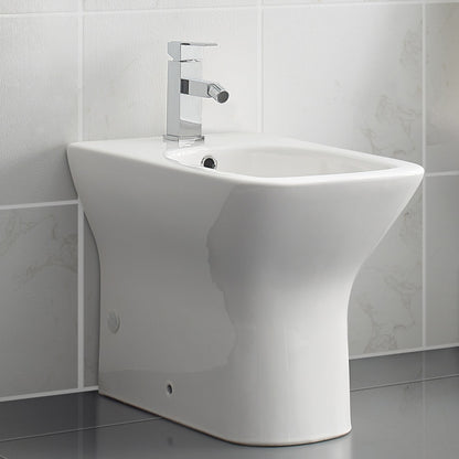Floor-mount classic bidet in glossy white with modern single-handle faucet and smooth curved design.