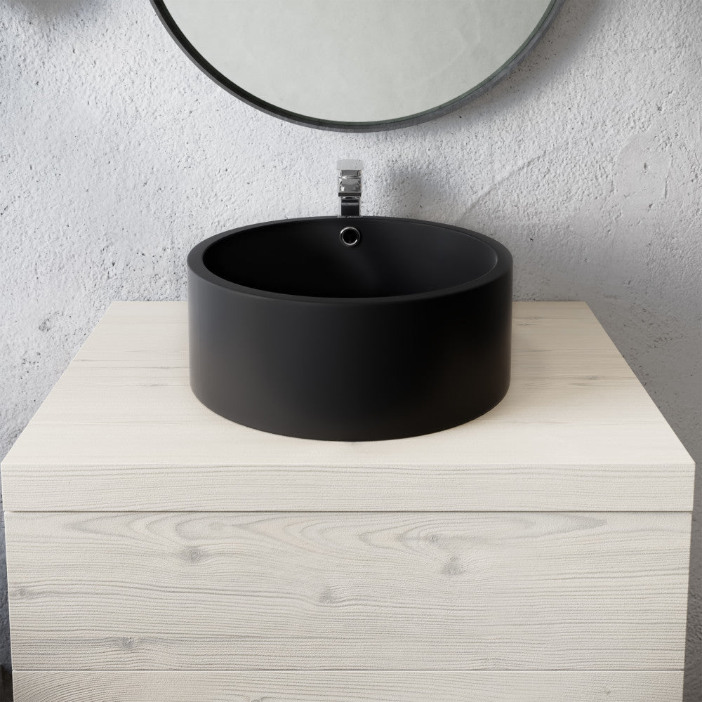 16.5” round vessel sink in matte black with smooth cylindrical design and centered drain hole.