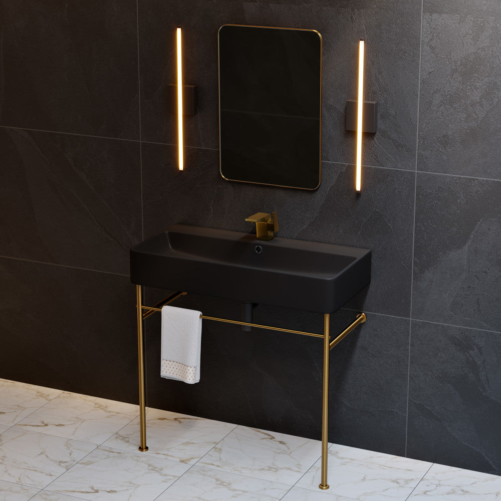 36-inch matte black ceramic console sink with brushed gold legs and towel bar.
